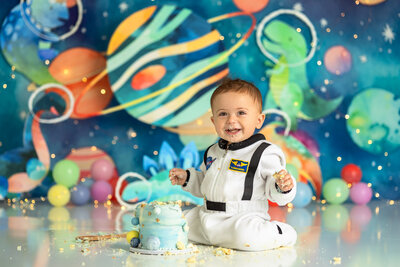 1 year old posing for a cake smash session with starry backdrop