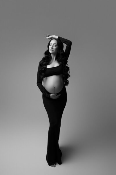 Austin maternity photographer black white studio portrait expecting mother dramatic lighting Round Rock Texas