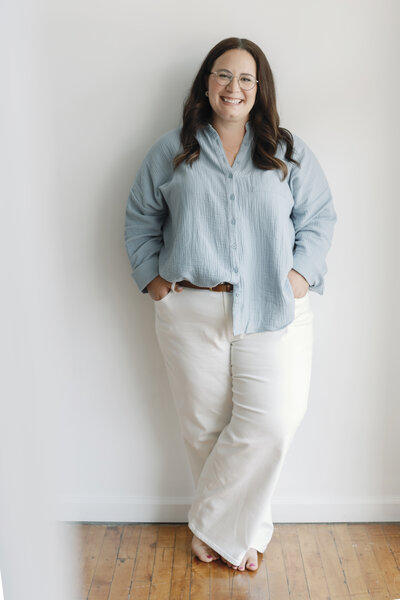 Cat smiling while leaning against a wall