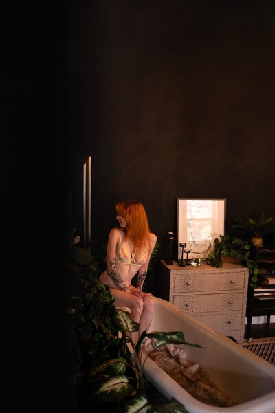 Beautiful redhead posing on a bathtub in Los Angeles Studio Boudoir photography session