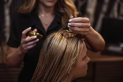 Client receiving an advanced red light facial treatment at Intrigue Salon, promoting relaxation and skin rejuvenation