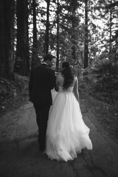 black and white image couple walking up trail