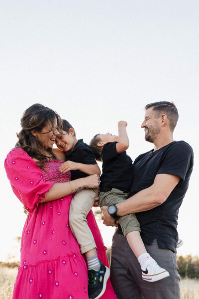 A Cleveland family shares laughter outdoors in a candid, joyful moment.