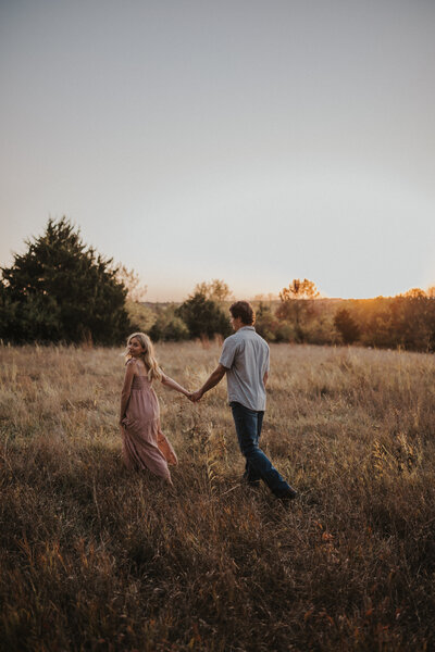 couple pose in field in kansas. romantic and timeless photoshoot