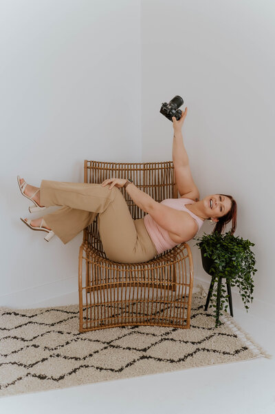 Alberta photographer, Cass, from Songbird Photography with her camera in an Edmonton studio