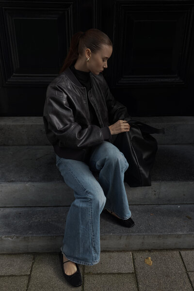 A woman holding a drink while reading a book. Showing that with anxiety therapy in Manhattan you can calm the inner chaos. An anxiety therapist can help you learn to relax and enjoy every day.