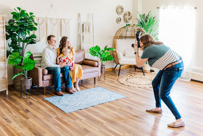 Family posing for photographer in studio