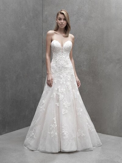 Elaborate lace appliques provide beautiful contrast to this sheath's softly structured crepe.