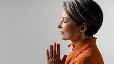 Woman practicing yoga in a peaceful setting, focusing on mindfulness and emotional well-being during menopause.