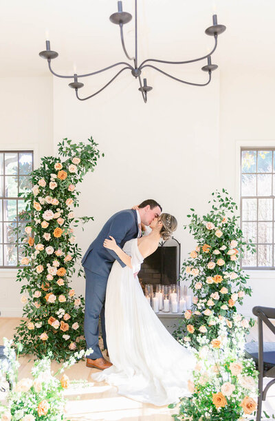 Groom kisses his bride during wedding ceremony at Hemlock Hospitality Virginia Wedding in Loudon County, Virginia. Captured by Charlottesville Wedding Photographer Bethany Aubre Photography.