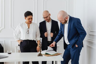 People standing around a desk working and discussing