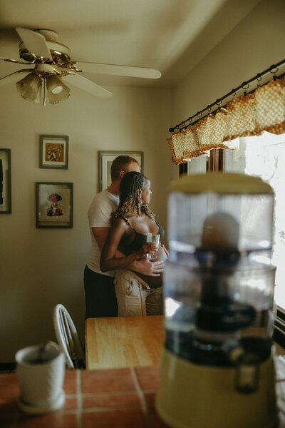 “Mother cuddling toddler in golden hour light.”
