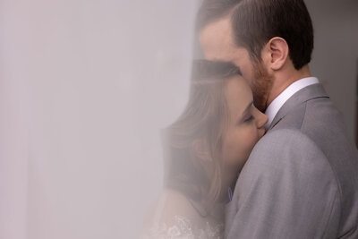 Intimate Summer wedding portraits at Walsh University with veil foreground