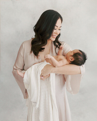 Bay Area family newborn photography of a mom holding newborn.