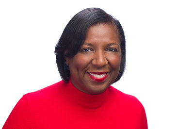 Black public relations specialist wearing red shirt headshot
