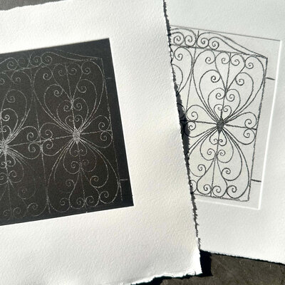 A finished black-on-white print featuring mirrored heart and scroll linework from the line reversal technique.