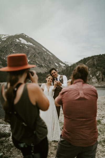 Photographer and videographer capturing a mountain elopement by a lake in Breckenridge, Colorado.