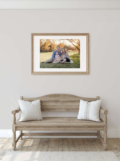 foyer with bench and framed and matted family photo on wall