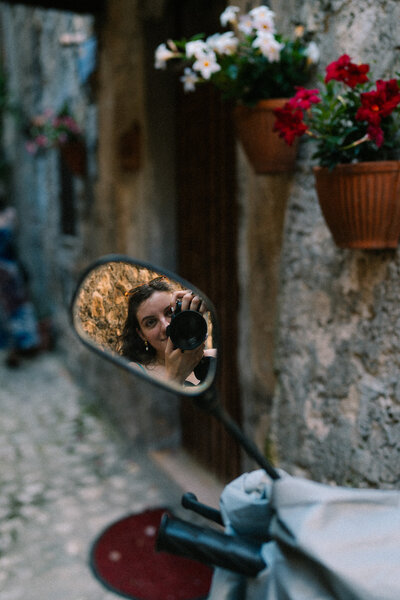 self portrait in mirror of moped