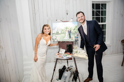 Couple sees live wedding painting during reception at White Sparrow Barn by wedding vendor, By B