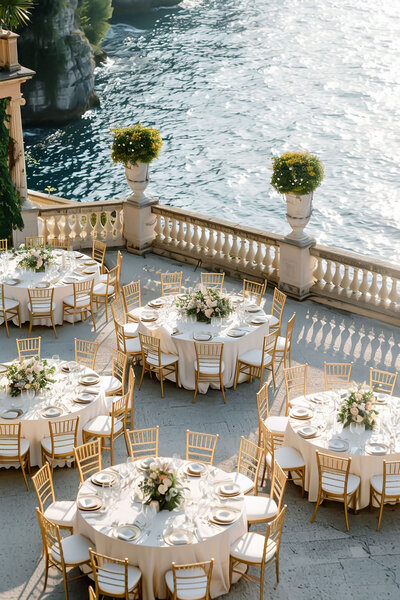 wedding reception tables outside next to water