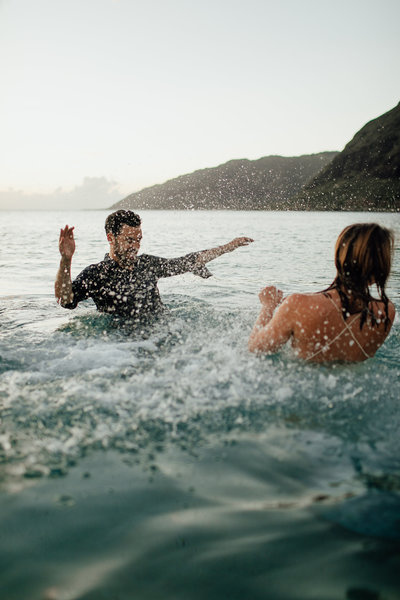 couple laughing in waves