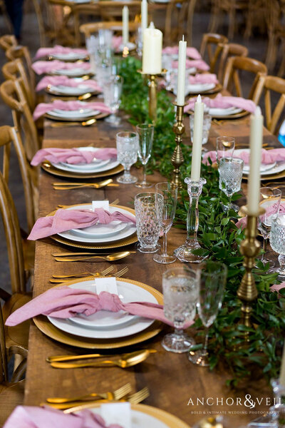 Reception table with pink napkins placed by Raleigh wedding planners