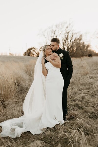 groom kissing brides cheek