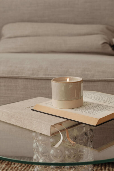 Close up of coffee table with books and a candle at Vancouver penthouse interior design project