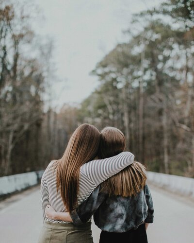 Girls in nature hugging