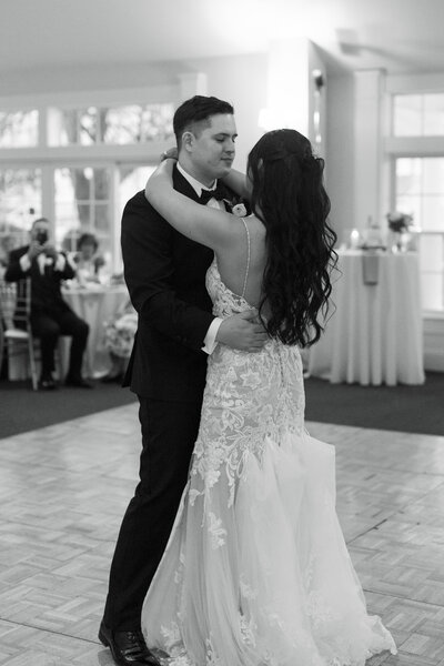 Couple embracing at Beaufort Hotel in  Beaufort, NC waterfront – romantic coastal wedding photography by Hailey Rae.