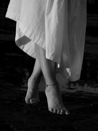 bare feet on the ocean sand