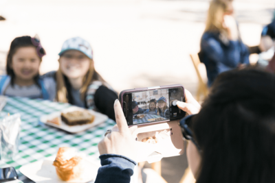 person taking a photo of smiling kids