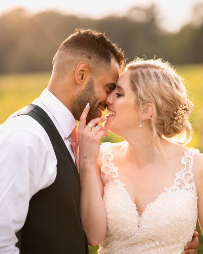 The bride and groom share a kiss during golden hour after their Finger Lakes wedding.