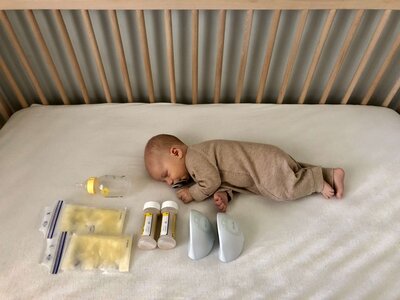 Newborn baby with breastfeeding products and milk