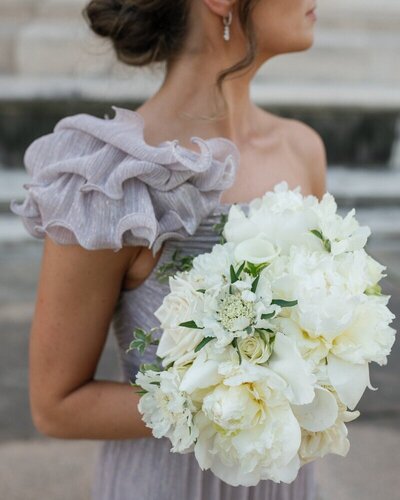 Bridesmaid with bouquet of white flowers