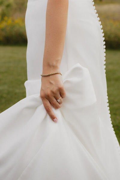 bride holding up her wedding gow
