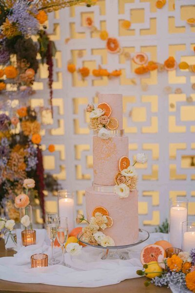 a Pink ornate cake against Hart and Main's stylish breezeblock wall