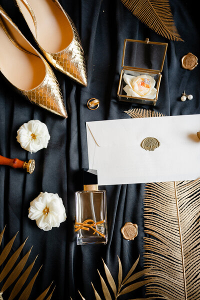 Luxury black, gold, ivory flat lay with gold bridal shoes