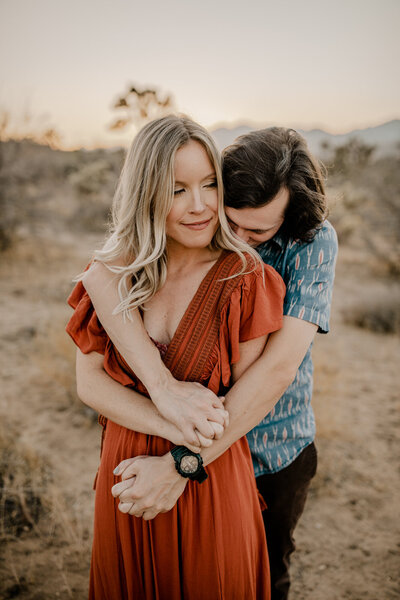 couple holding each other in the desert