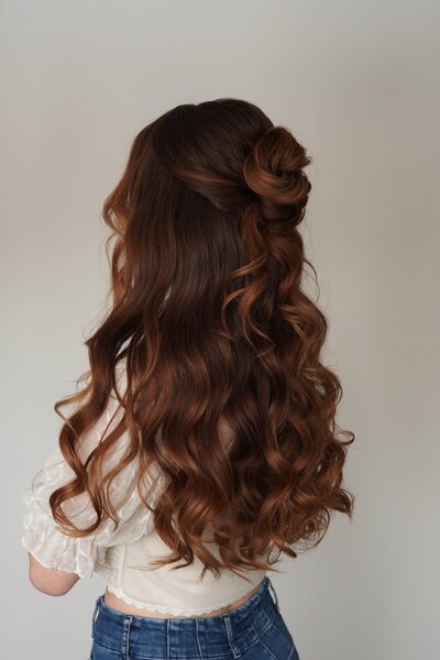 Bridesmaid wearing a curled half-up, half-down style — timeless and feminine wedding party look by Klover Beauty.