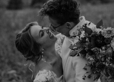 Two brides smile at each other