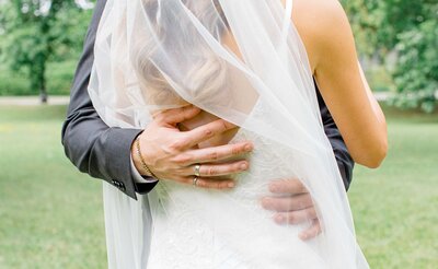 Grey Loft Studio - Bethany and Luc Barette - Wedding Photography Wedding Videography Ottawa - close up photo of groom's ring hand on bride's back