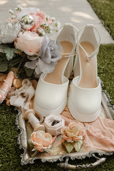 Wedding photographer capturing stunning wedding details such as elegant rings, floral arrangements, and table settings, showcasing the beauty and personalization of every moment for timeless memories.
