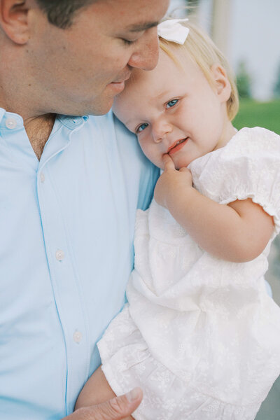 dad snuggling with little girl