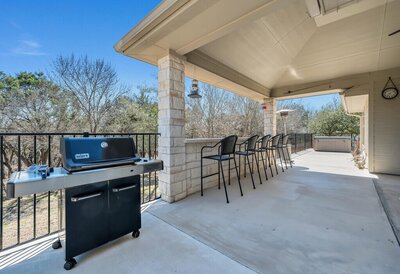 Deck and bar height seating for four at this three-bedroom, two-bathroom vacation rental lake house that sleeps eight just steps away from Stillhouse Hollow Lake in Belton, TX.