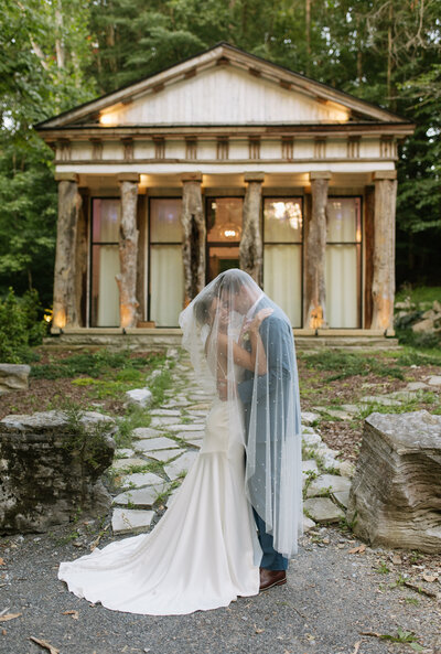 Tucked under her veil, the couple shared a quiet, intimate moment in front of a historic chapel in East Tennessee. This true-to-color, documentary-style portrait captures the elegance and emotion of their wedding day—raw, romantic, and completely timeless.