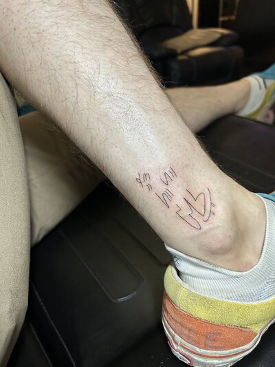 A leg with a fresh tiny tattoo