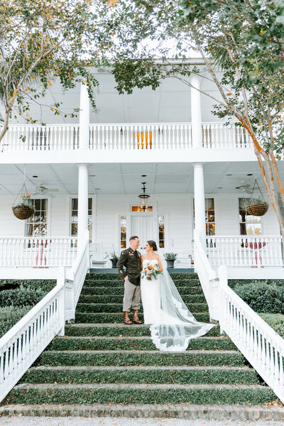 bride and groom on stairs at Old Wide Awake Plantation