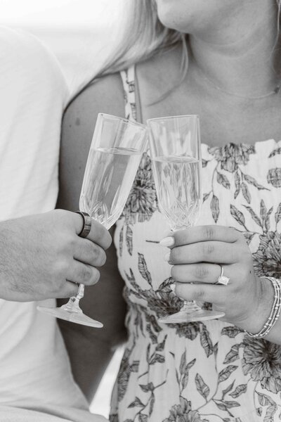 Greyscale image of couple toasting champagne